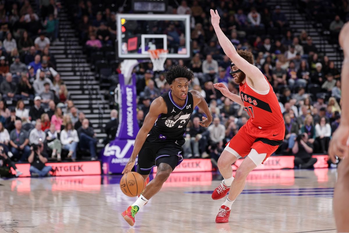 Mar 14, 2025; Salt Lake City, Utah, USA;  Utah Jazz guard Collin Sexton (2) runs up the court while guarded by Toronto Raptors forward Jamison Battle (77) during the first quarter at Delta Center. Mandatory Credit: Chris Nicoll-Imagn Images