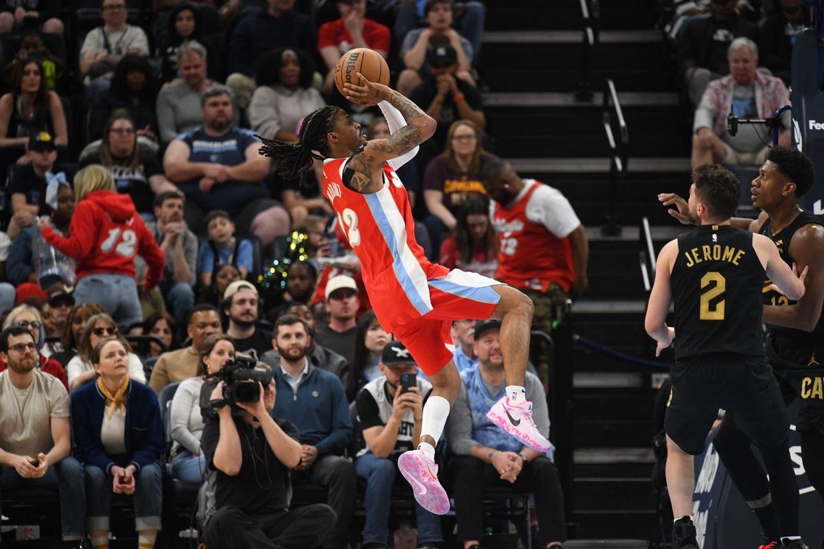 Mar 14, 2025; Memphis, Tennessee, USA; Memphis Grizzlies point guard Ja Morant (12) levitates while shooting a jump shot in the 4th quarter of the Cleveland Cavaliers vs. Memphis Grizzlies game at FedExForum. Mandatory Credit: Matthew Smith-Imagn Images