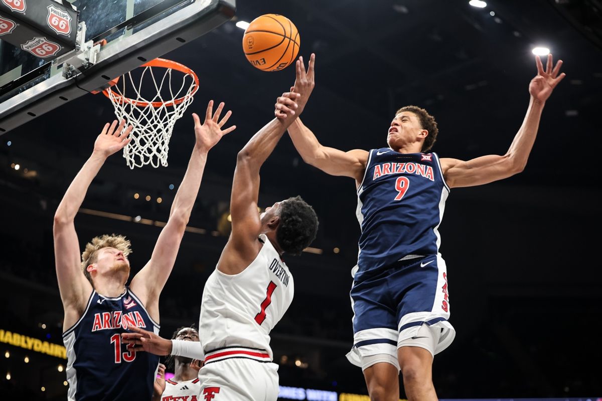 Mar 14, 2025; Kansas City, MO, USA; Texas Tech Red Raiders guard Kevin Overton (1) shoots the ball around Arizona Wildcats forward Carter Bryant (9) during the first half at T-Mobile Center. Mandatory Credit: William Purnell-Imagn Images