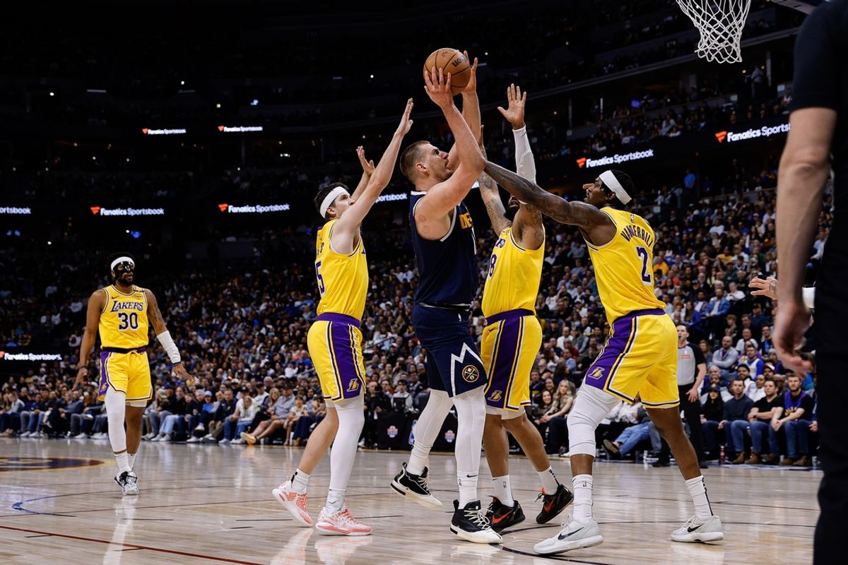 Mar 14, 2025; Denver, Colorado, USA; Denver Nuggets center Nikola Jokic (15) drives to the basket against Los Angeles Lakers forward Markieff Morris (88) and guard Austin Reaves (15) and forward Jarred Vanderbilt (2) in the second quarter at Ball Arena. Mandatory Credit: Isaiah J. Downing-Imagn Images