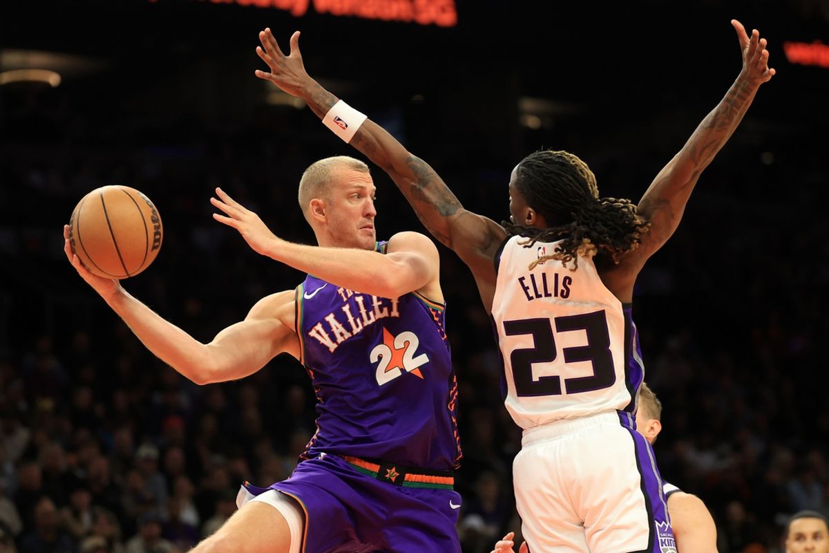Mar 14, 2025; Phoenix, Arizona, USA; Phoenix Suns center Mason Plumlee (22) makes a pass against Sacramento Kings guard Keon Ellis (23) during the first half at Footprint Center. Mandatory Credit: Mark J. Rebilas-Imagn Images