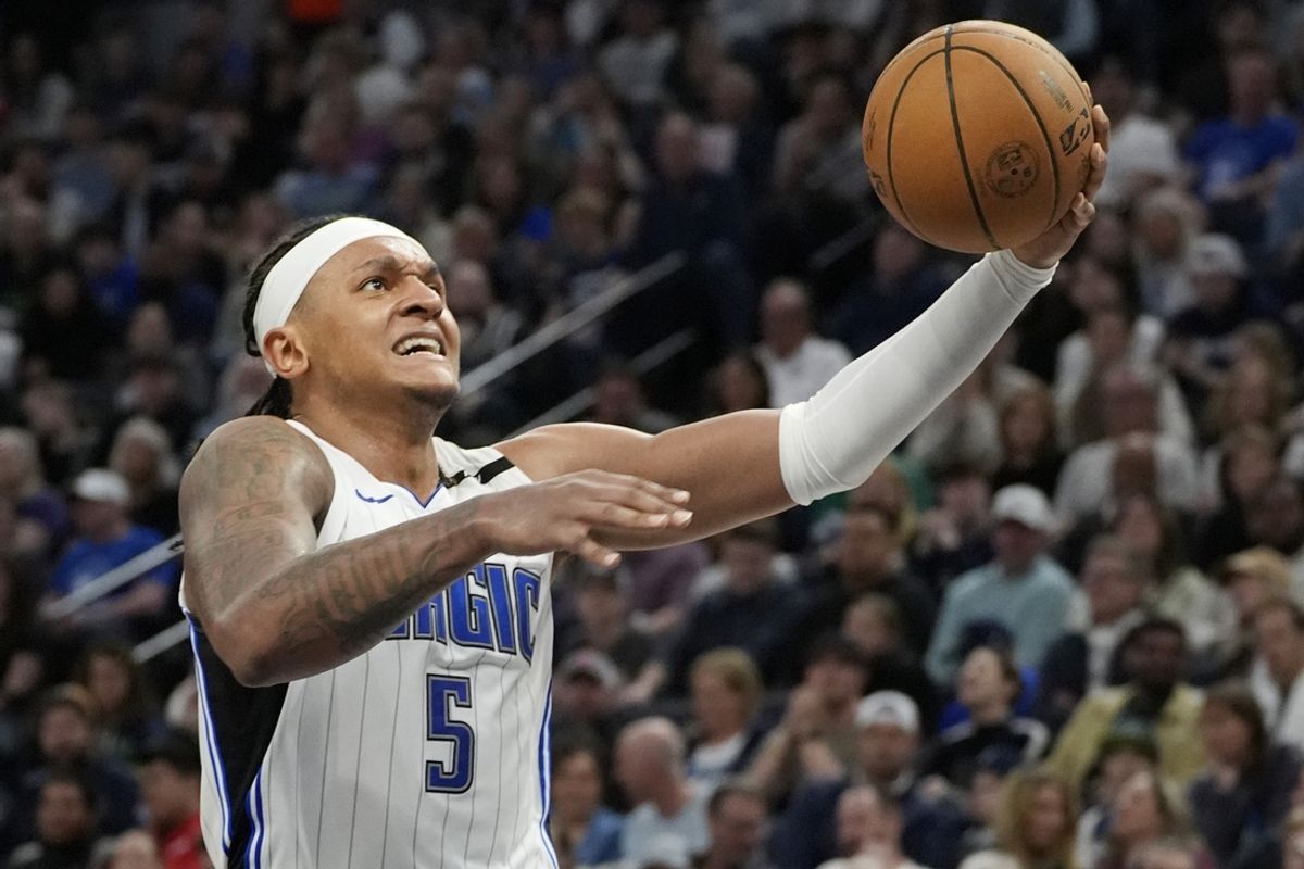 Mar 14, 2025; Minneapolis, Minnesota, USA; Orlando Magic forward Paolo Banchero (5) goes to the basket against the Minnesota Timberwolves in the third quarter at Target Center. Mandatory Credit: Bruce Kluckhohn-Imagn Images
