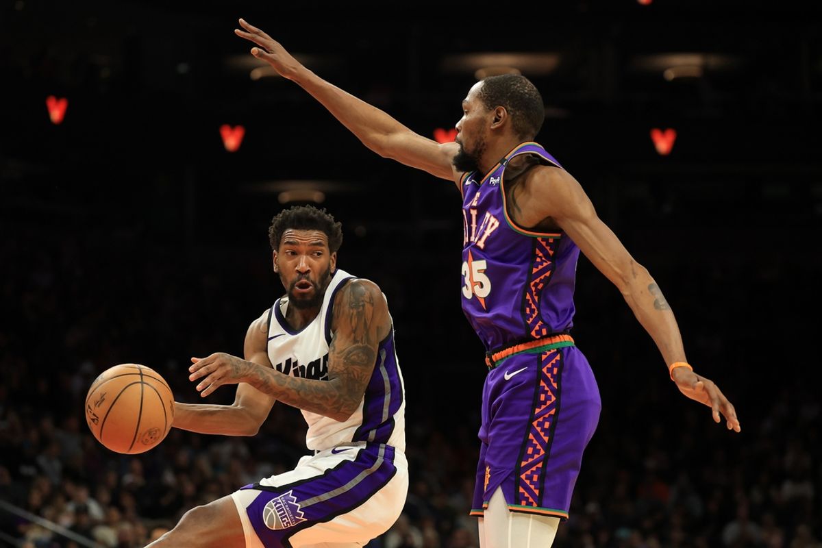 Mar 14, 2025; Phoenix, Arizona, USA; Sacramento Kings guard Malik Monk (0) makes a pass against Phoenix Suns forward Kevin Durant (35) during the second half at Footprint Center. Mandatory Credit: Mark J. Rebilas-Imagn Images