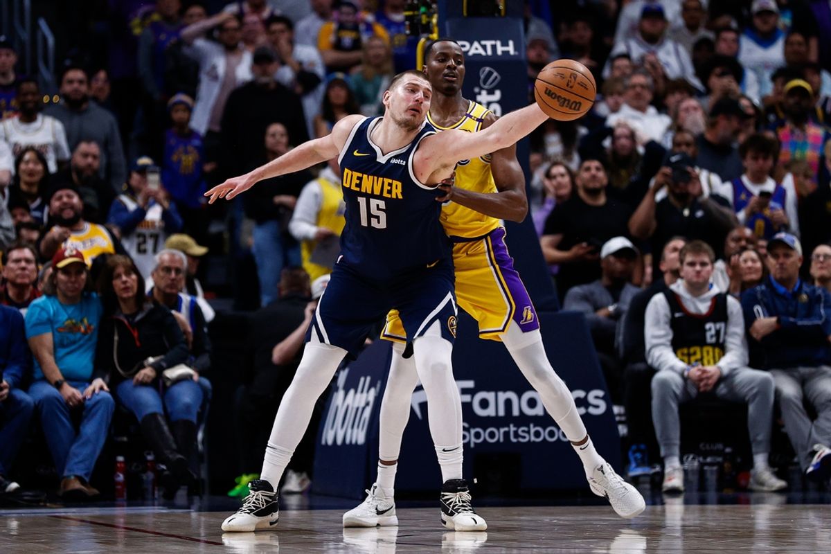Denver Nuggets center Nikola Jokic (15) reaches for the ball ahead of Los Angeles Lakers center Christian Koloko (10) in the fourth quarter at Ball Arena.