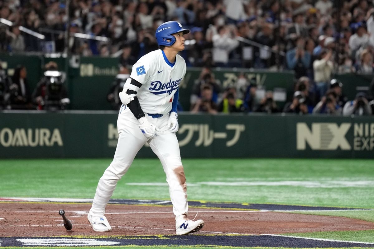 Mar 15, 2025; Bunkyo, Tokyo, Japan; Los Angeles Dodgers designated hitter Shohei Ohtani (17) watches the flight of his home run against the Yomiuri Giants during the third inning at Tokyo Dome. Mandatory Credit: Darren Yamashita-Imagn Images