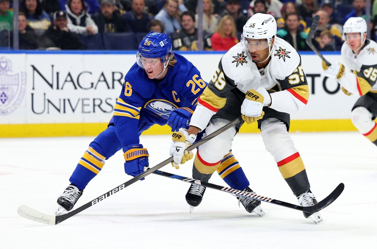 Mar 15, 2025; Buffalo, New York, USA;  Buffalo Sabres defenseman Rasmus Dahlin (26) and Vegas Golden Knights right wing Keegan Kolesar (55) look for the puck during the first period at KeyBank Center. Mandatory Credit: Timothy T. Ludwig-Imagn Images