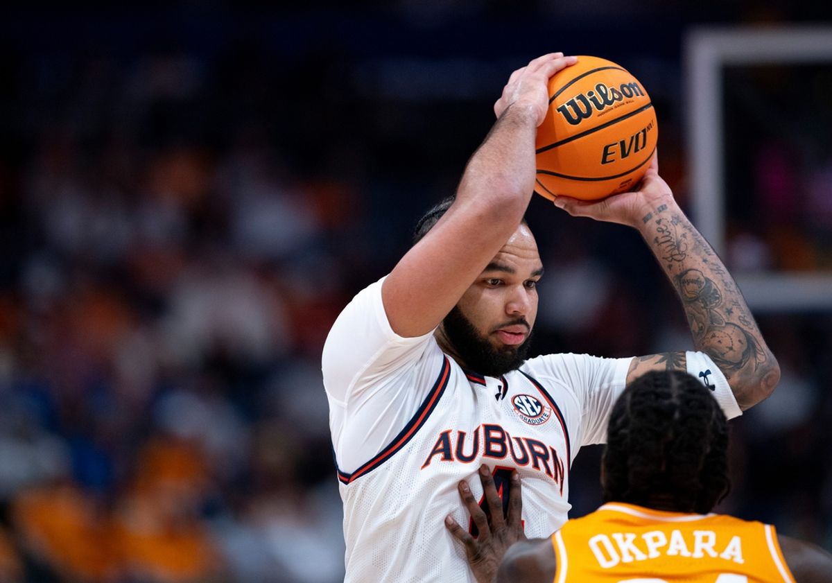 Auburn forward Johni Broome (4) pulls down a rebound against Tennessee forward Felix Okpara (34)during the first half of their semifinal game of the SEC Men's Basketball Tournament at Bridgestone Arena in Nashville, Tenn., Saturday, March 15, 2025.