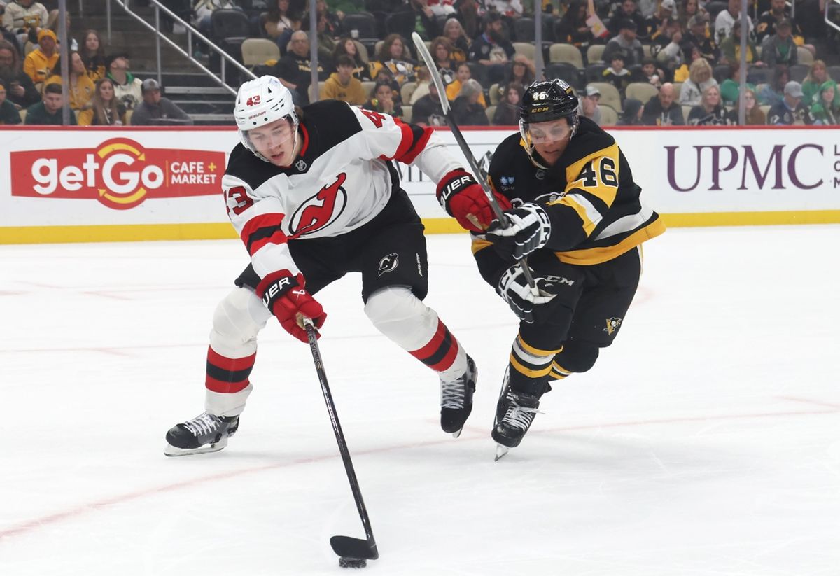 Mar 15, 2025; Pittsburgh, Pennsylvania, USA;  New Jersey Devils defenseman Luke Hughes (43) chases the puck against pressure from Pittsburgh Penguins center Blake Lizotte (46) during the first period at PPG Paints Arena. Mandatory Credit: Charles LeClaire-Imagn Images