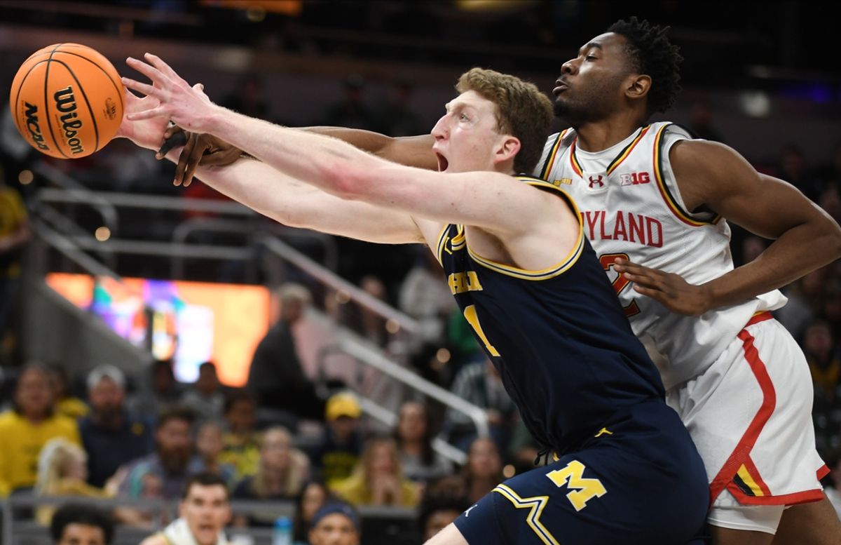 Mar 15, 2025; Indianapolis, IN, USA; Michigan Wolverines center Danny Wolf (1) and Maryland Terrapins forward Jordan Geronimo (22) go for a rebound during the first half at Gainbridge Fieldhouse. Mandatory Credit: Robert Goddin-Imagn Images