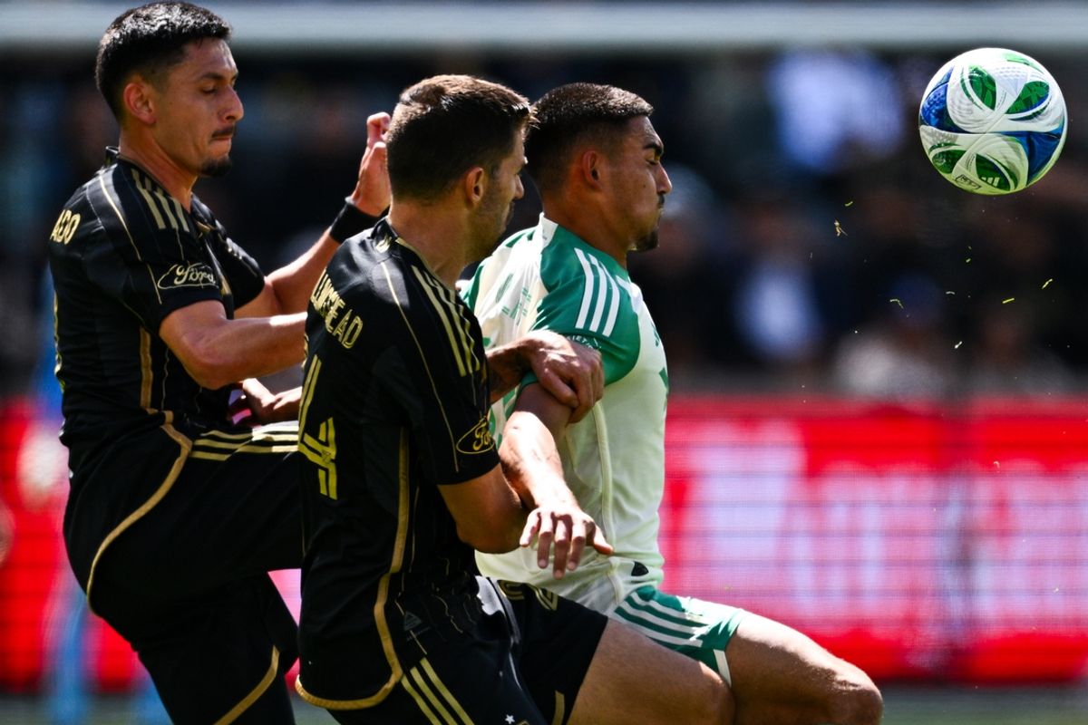 Mar 15, 2025; Los Angeles, California, USA; Austin FC midfielder Owen Wolff (33) attempts to handle the ball while pressured by Los Angeles FC defender Ryan Hollingshead (24) and midfielder Mark Delgado (8) during the first half at BMO Stadium. Mandatory Credit: Kelvin Kuo-Imagn Images