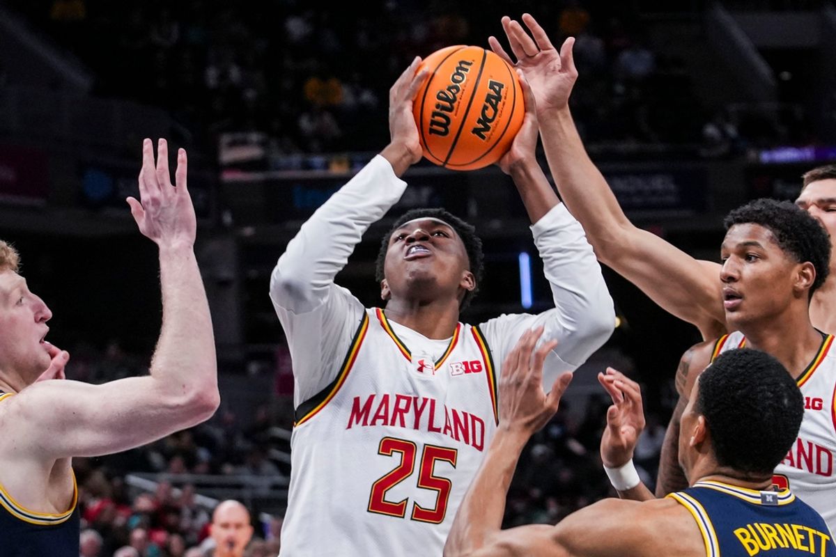 Maryland Terrapins center Derik Queen (25) goes up for a basket against Michigan Wolverines center Danny Wolf (1) and Michigan Wolverines guard Nimari Burnett (4) on Saturday, March 15, 2025, in a semifinals game at the 2025 TIAA Big Ten Men’s Basketball Tournament between the Michigan Wolverines and the Maryland Terrapins at Gainbridge Fieldhouse in Indianapolis.