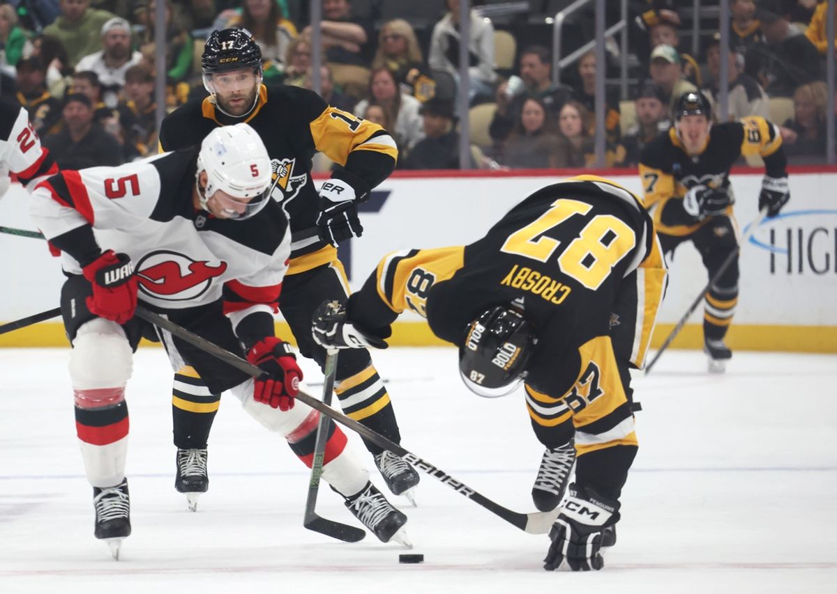 Mar 15, 2025; Pittsburgh, Pennsylvania, USA;  New Jersey Devils defenseman Brenden Dillon (5) battles for the puck against Pittsburgh Penguins center Sidney Crosby (87) during the third period at PPG Paints Arena. Mandatory Credit: Charles LeClaire-Imagn Images
