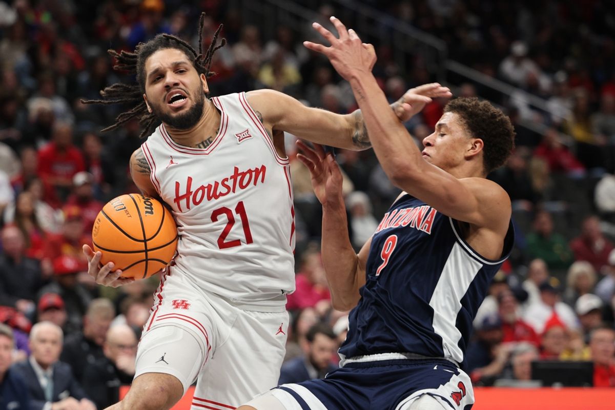 Mar 15, 2025; Kansas City, MO, USA; Houston Cougars guard Emanuel Sharp (21) goes to the basket against Arizona Wildcats forward Carter Bryant (9) during the first half for the Big 12 Conference Tournament Championship game at T-Mobile Center. Mandatory Credit: William Purnell-Imagn Images