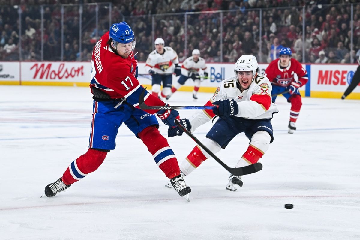 Mar 15, 2025; Montreal, Quebec, CAN; Montreal Canadiens right wing Josh Anderson (17) shoots the puck against Florida Panthers right wing Mackie Samoskevich (25) in the first period at Bell Centre. Mandatory Credit: David Kirouac-Imagn Images