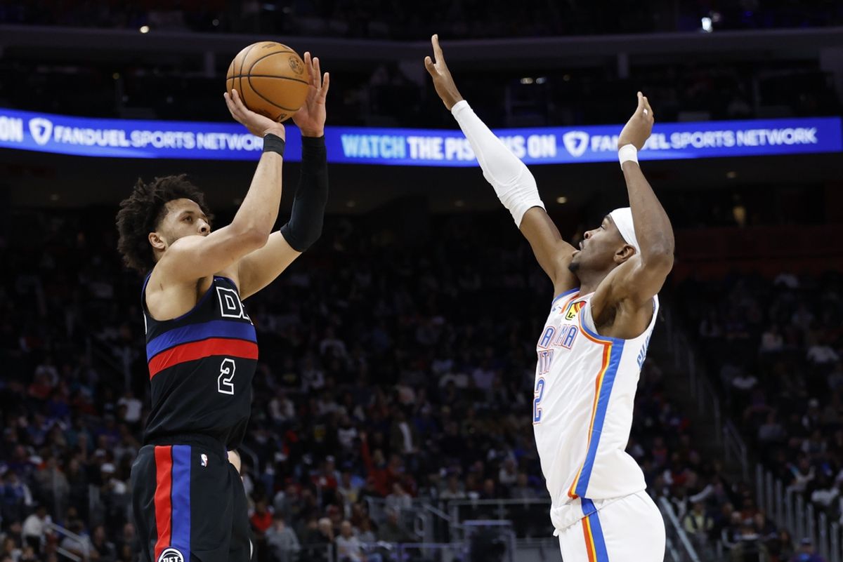 Mar 15, 2025; Detroit, Michigan, USA;  Detroit Pistons guard Cade Cunningham (2) shoots on Oklahoma City Thunder guard Shai Gilgeous-Alexander (2) in the first half at Little Caesars Arena. Mandatory Credit: Rick Osentoski-Imagn Images