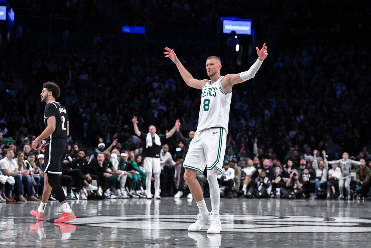 Mar 15, 2025; Brooklyn, New York, USA; Boston Celtics center Kristaps Porzingis (8) reacts after a three point basket during the second half against the Brooklyn Nets at Barclays Center. Mandatory Credit: John Jones-Imagn Images