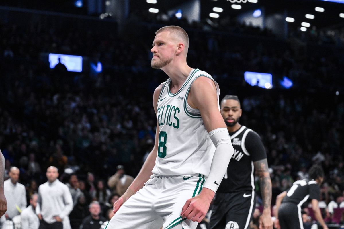 Mar 15, 2025; Brooklyn, New York, USA; Boston Celtics center Kristaps Porzingis (8) reacts after dunking the ball against the Brooklyn Nets during the second half at Barclays Center. Mandatory Credit: John Jones-Imagn Images
