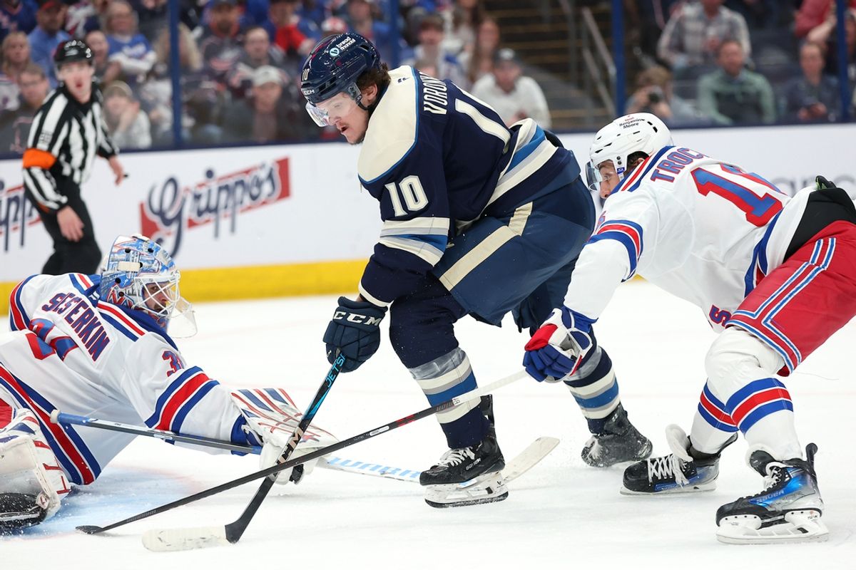 Mar 15, 2025; Columbus, Ohio, USA;  New York Rangers goaltender Igor Shesterkin (31) saves the puck as Columbus Blue Jackets left wing Dmitri Voronkov (10) attempts to score and New York Rangers center Vincent Trocheck (16) defends during the second period at Nationwide Arena. Mandatory Credit: Joseph Maiorana-Imagn Images
