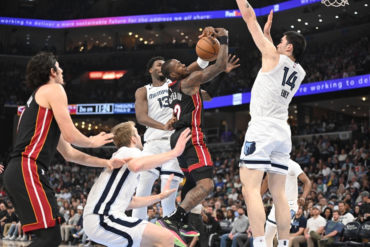 Mar 15, 2025; Memphis, Tennessee, USA; Miami Heat shooting guard Terry Rozier (2) jumps to the rim while surrounded by defenders in the second quarter in the game against the Memphis Grizzlies at FedExForum. Mandatory Credit: Matthew Smith-Imagn Images