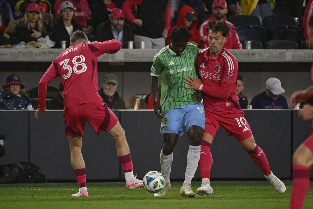 Mar 15, 2025; St. Louis, Missouri, USA; St. Louis CITY SC defender Jannes Horn (38) and St. Louis CITY SC midfielder Eduard Lowen (10) battle Seattle Sounders FC forward Georgi Minoungou (93) for the ball in the first half at Energizer Park. Mandatory Credit: Joe Puetz-Imagn Images
