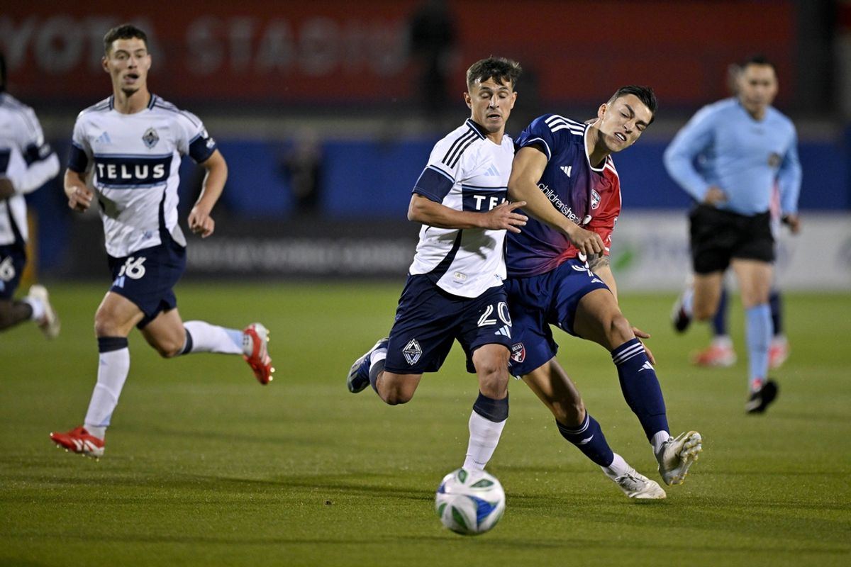 Mar 15, 2025; Frisco, Texas, USA; Vancouver Whitecaps FC midfielder Andres Cubas (20) and FC Dallas forward Petar Musa (9) chase the ball during the first half at Toyota Stadium. Mandatory Credit: Jerome Miron-Imagn Images
