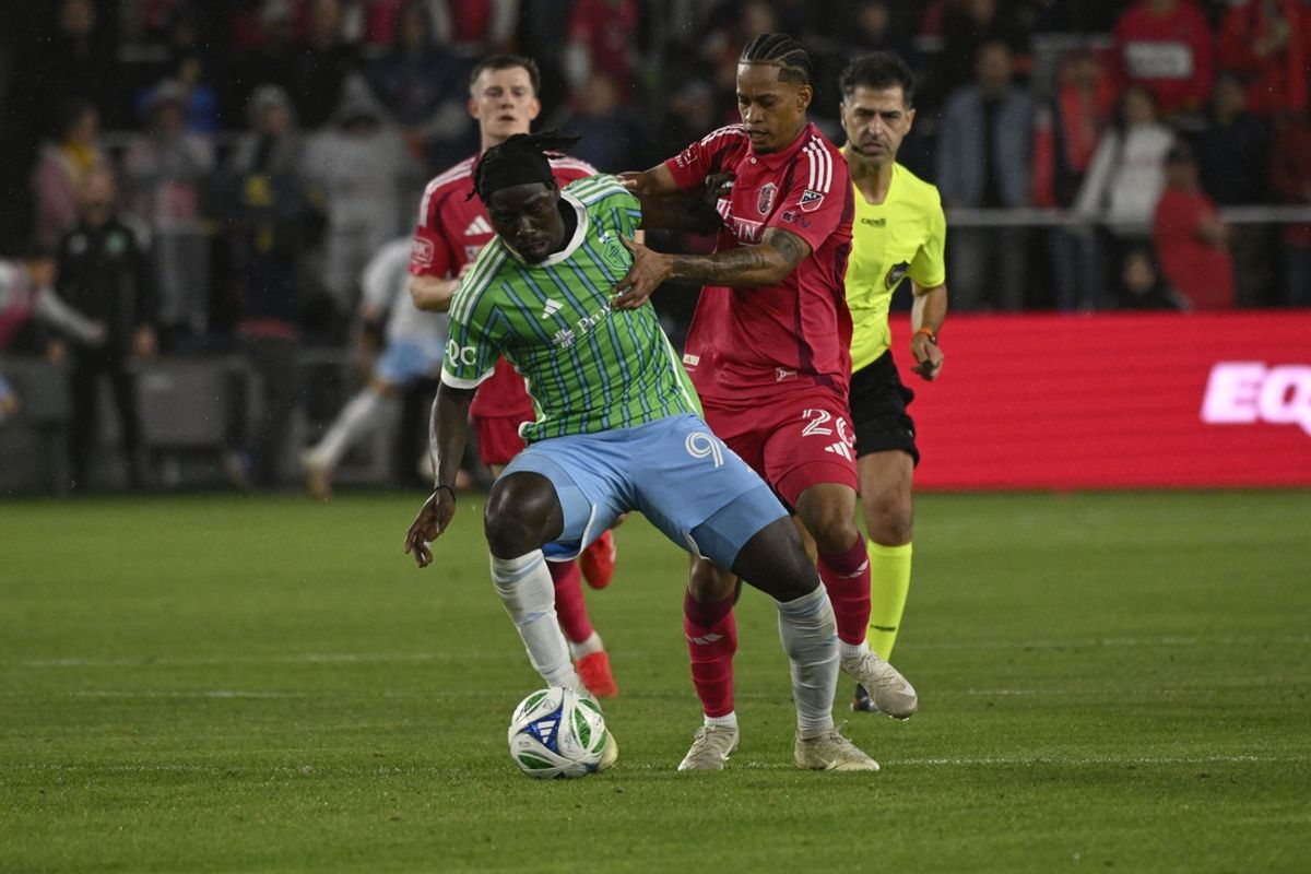 Mar 15, 2025; St. Louis, Missouri, USA; Seattle Sounders FC forward Georgi Minoungou (93) and St. Louis CITY SC midfielder Akil Watts (20) battle for the ball in the first half at Energizer Park. Mandatory Credit: Joe Puetz-Imagn Images