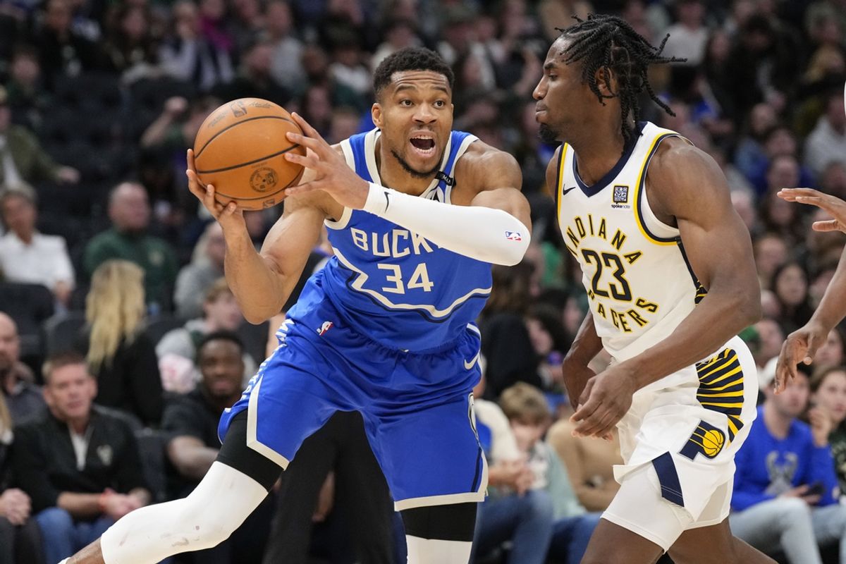 Mar 15, 2025; Milwaukee, Wisconsin, USA;  Milwaukee Bucks forward Giannis Antetokounmpo (34) looks to pass the ball around Indiana Pacers forward Aaron Nesmith (23) during the third quarter at Fiserv Forum. Mandatory Credit: Jeff Hanisch-Imagn Images