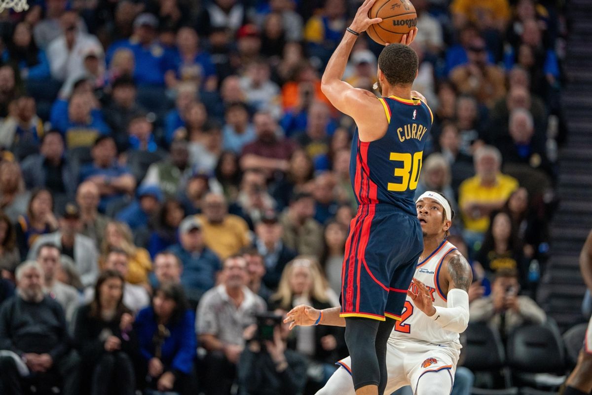 Mar 15, 2025; San Francisco, California, USA; Golden State Warriors guard Stephen Curry (30) makes a three point basket against New York Knicks guard Miles McBride (2) during the second quarter at Chase Center. Mandatory Credit: Neville E. Guard-Imagn Images