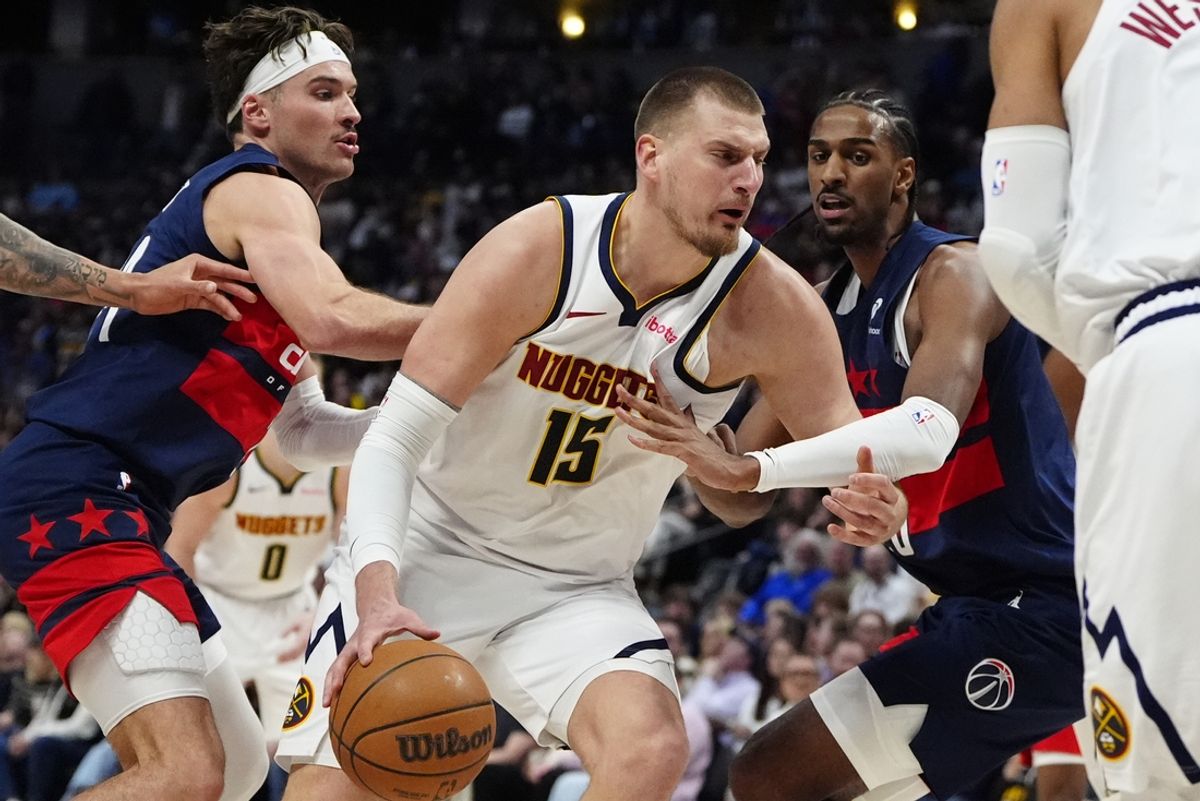 Mar 15, 2025; Denver, Colorado, USA; Washington Wizards forward Alex Sarr (20) defends Denver Nuggets center Nikola Jokic (15) in the second quarter at Ball Arena. Mandatory Credit: Ron Chenoy-Imagn Images
