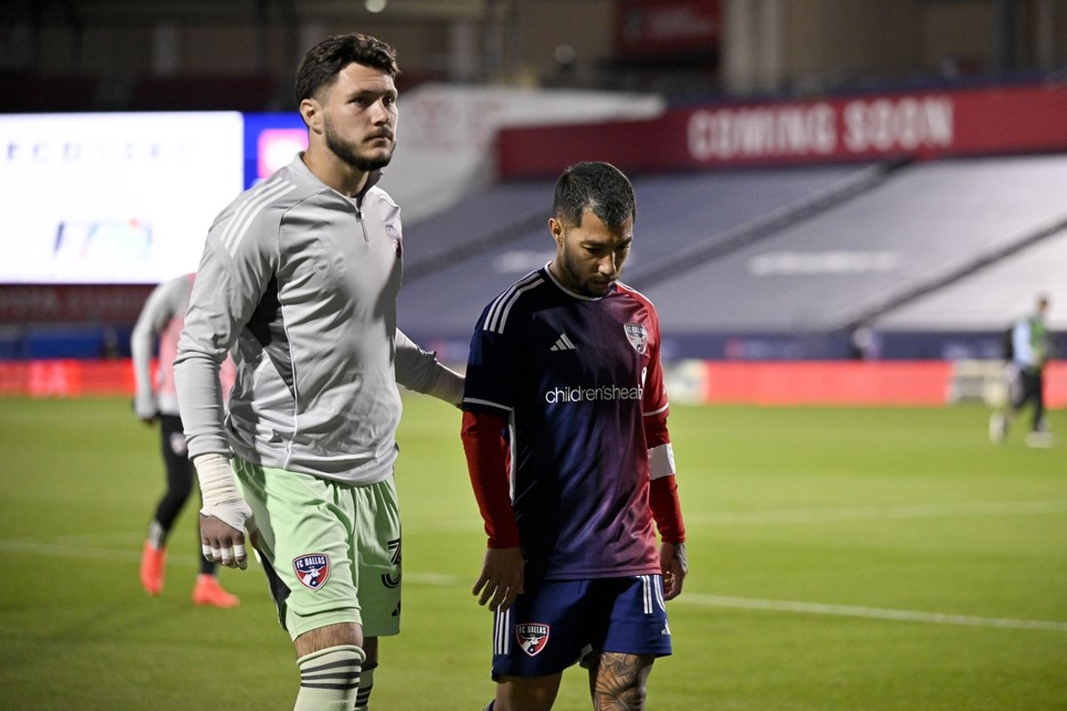 Mar 15, 2025; Frisco, Texas, USA; FC Dallas goalkeeper Michael Collodi (30) and midfielder Luciano Acosta (10) walk off the field after the loss to Vancouver Whitecaps FC at Toyota Stadium. Mandatory Credit: Jerome Miron-Imagn Images