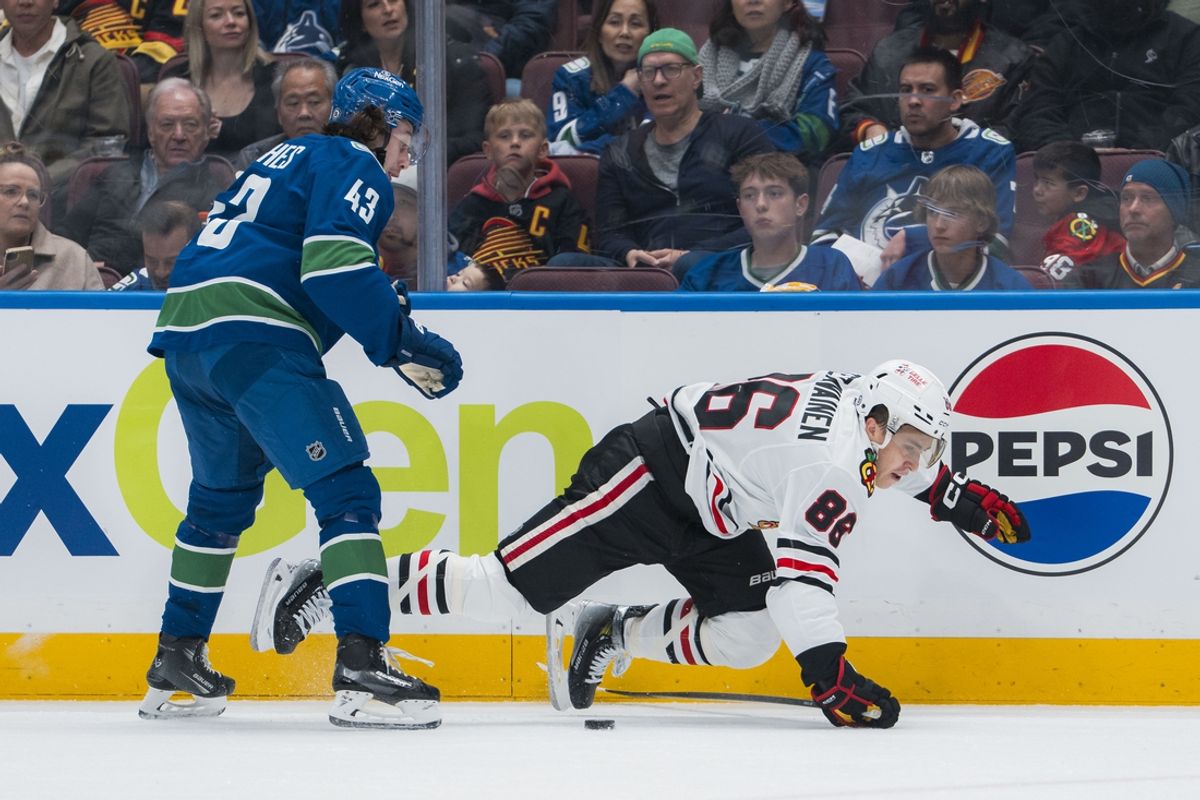 Mar 15, 2025; Vancouver, British Columbia, CAN; Vancouver Canucks defenseman Quinn Hughes (43) checks Chicago Blackhawks forward Teuvo Teravainen (86) in the first period at Rogers Arena. Mandatory Credit: Bob Frid-Imagn Images