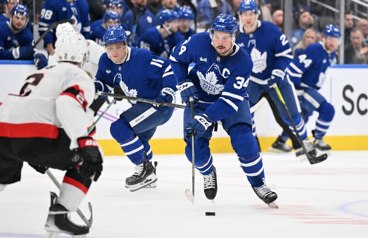 Mar 15, 2025; Toronto, Ontario, CAN;  Toronto Maple Leafs forward Auston Matthews (34) skates with the puck ahead of forward Max Domi (11) in the first period against the Ottawa Senators at Scotiabank Arena. Mandatory Credit: Dan Hamilton-Imagn Images