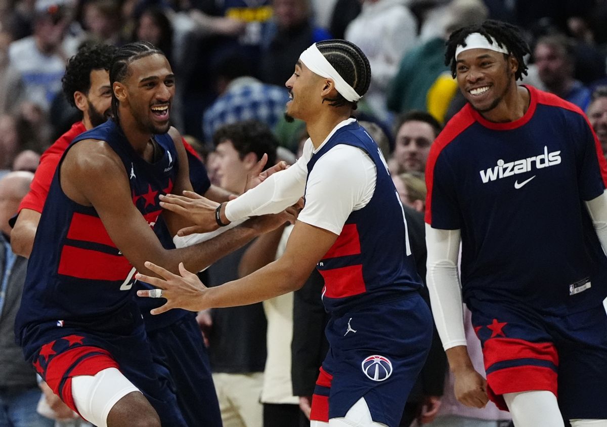 Mar 15, 2025; Denver, Colorado, USA; Washington Wizards guard Jordan Poole (13) (center) celebrates with teammates following his three-point basket in the fourth quarter against the Denver Nuggets at Ball Arena. Mandatory Credit: Ron Chenoy-Imagn Images