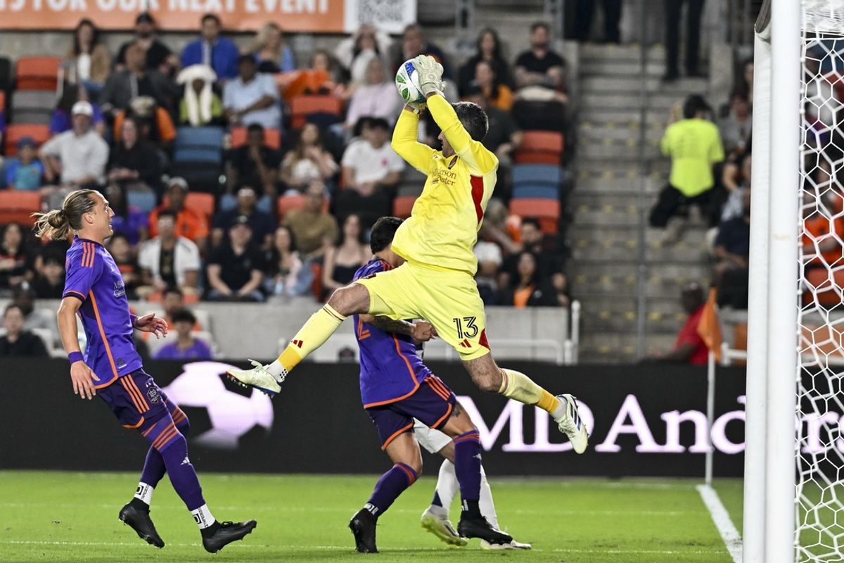 Mar 15, 2025; Houston, Texas, USA; Houston Dynamo goalkeeper Andrew Tarbell (13) makes a leaping save against the Real Salt Lake during the first half at Shell Energy Stadium. Mandatory Credit: Maria Lysaker-Imagn Images