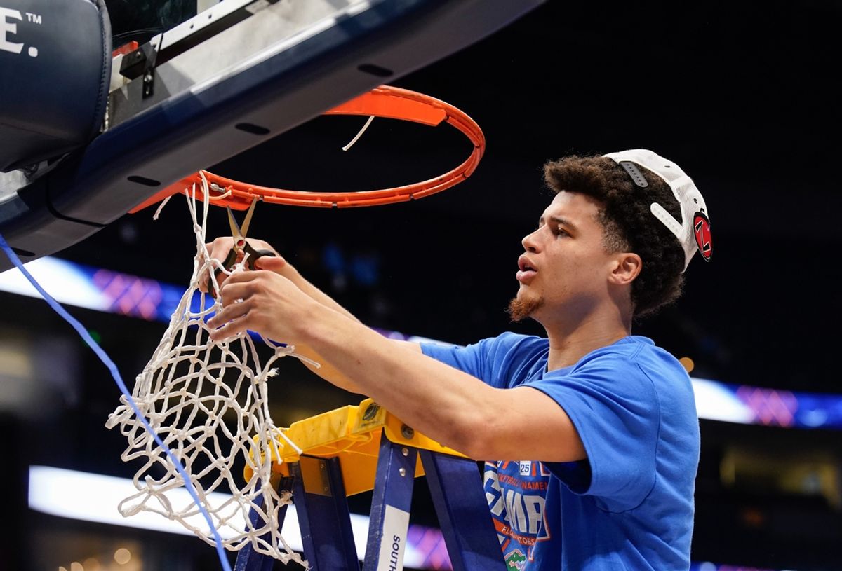 Florida guard Walter Clayton Jr. (1) cuts down his piece of the net as the team celebrates their win over Tennessee after the Southeastern Conference tournament championship at Bridgestone Arena in Nashville, Tenn., Sunday, March 16, 2025.