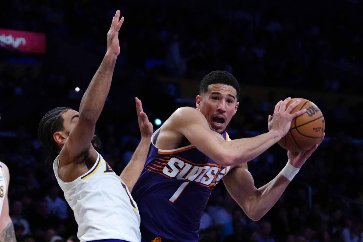 Mar 16, 2025; Los Angeles, California, USA; Phoenix Suns guard Devin Booker (1) is defended by Los Angeles Lakers guard Gabe Vincent (7) in the second half at Crypto.com Arena. Mandatory Credit: Kirby Lee-Imagn Images