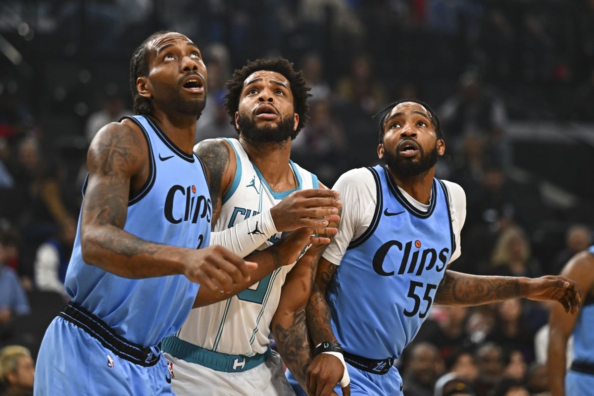 Mar 16, 2025; Inglewood, California, USA; Charlotte Hornets forward Miles Bridges (0) looks to rebound against LA Clippers forward Kawhi Leonard (2) and forward Derrick Jones Jr. (55) during the first half at Intuit Dome. Mandatory Credit: Jonathan Hui-Imagn Images
