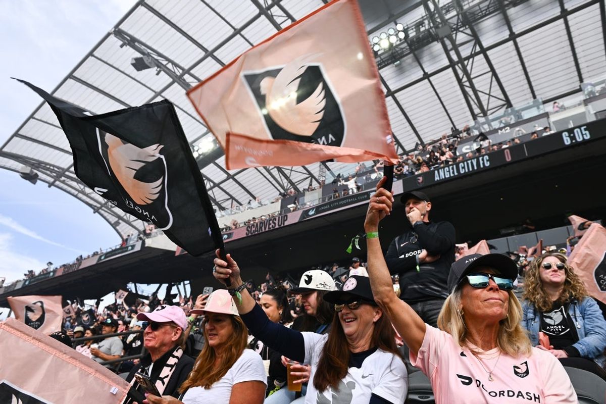 Mar 16, 2025; Los Angeles, California, USA; Angel City FC fans wave flags as players are introduced before the game against the San Diego Wave at BMO Stadium. Mandatory Credit: Kelvin Kuo-Imagn Images