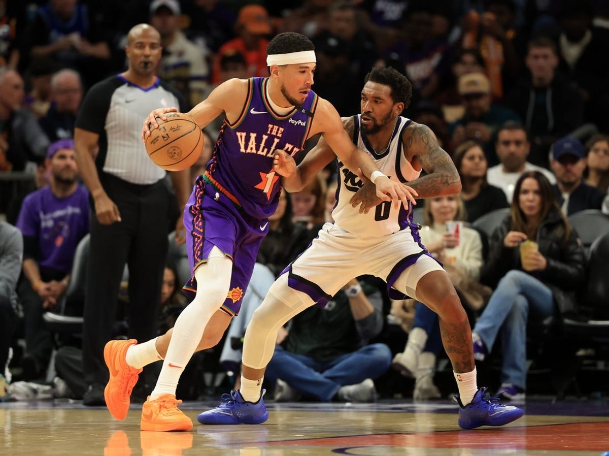 Mar 14, 2025; Phoenix, Arizona, USA; Phoenix Suns guard Devin Booker (1) against Sacramento Kings guard Malik Monk (0) at Footprint Center. Mandatory Credit: Mark J. Rebilas-Imagn Images