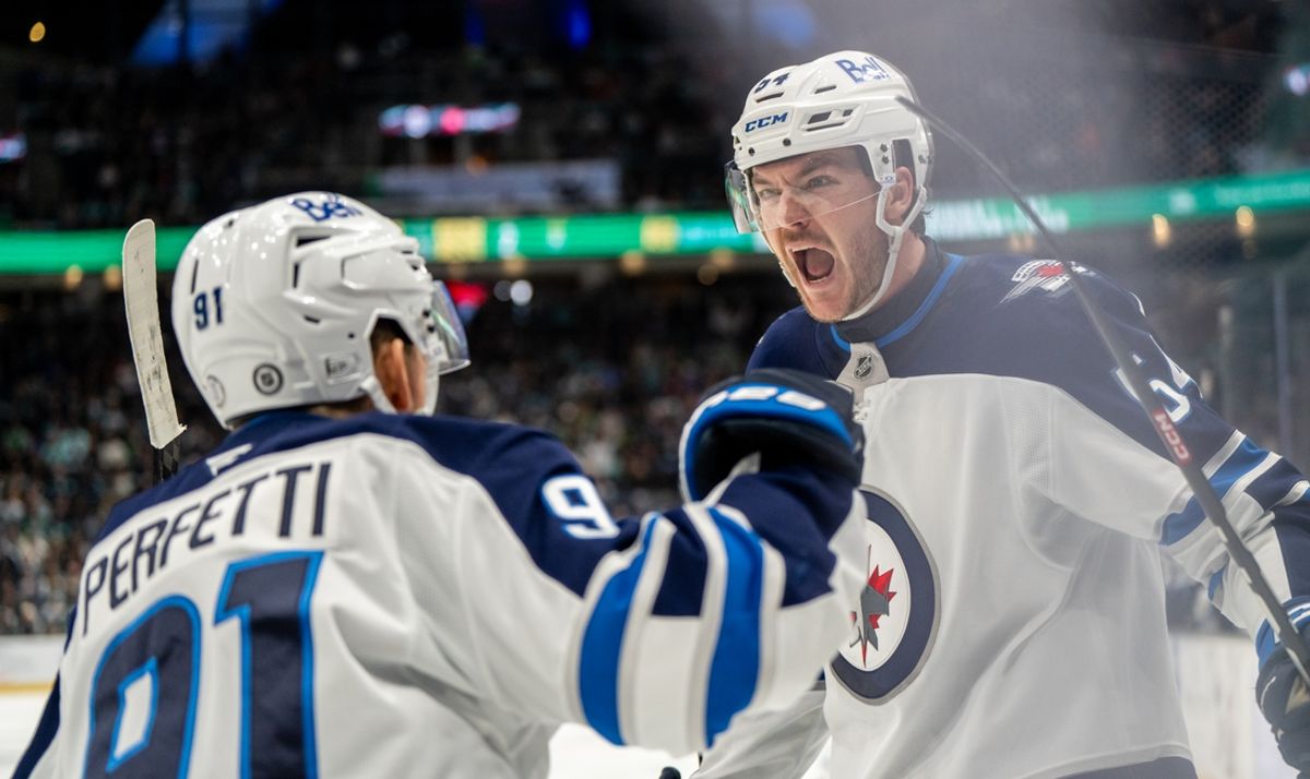 Mar 16, 2025; Seattle, Washington, USA;  Winnipeg Jets defenseman Dylan Samberg (54) celebrates scoring a goal forward Cole Perfetti (91) against the Seattle Kraken during overgtime at Climate Pledge Arena. Mandatory Credit: Stephen Brashear-Imagn Images
