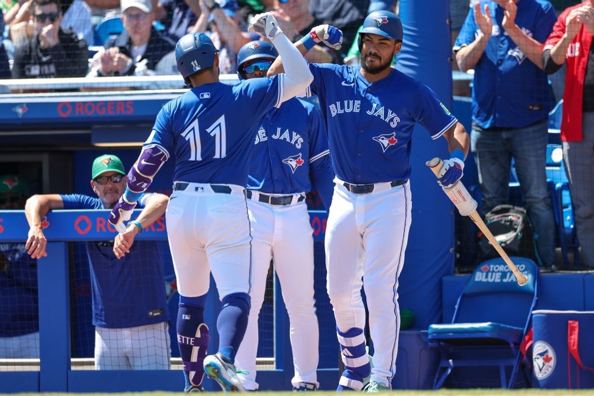 Mar 17, 2025; Dunedin, Florida, USA; Toronto Blue Jays shortstop Bo Bichette (11) celebrates with outfielder Anthony Santander (25) after hitting a home run against the New York Yankees in the second inning during spring training at TD Ballpark. Mandatory Credit: Nathan Ray Seebeck-Imagn Images