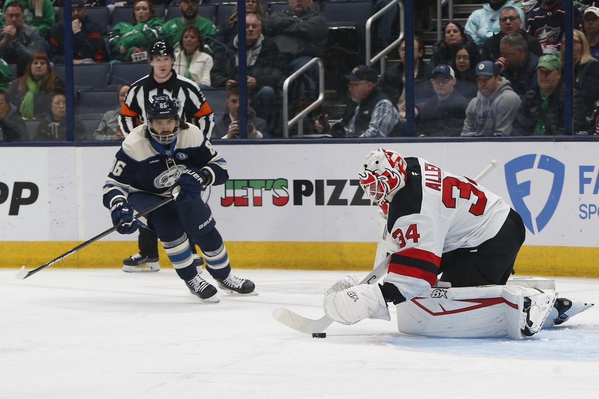 Mar 17, 2025; Columbus, Ohio, USA; New Jersey Devils goalie Jake Allen (34) makes a save as Columbus Blue Jackets right wing Kirill Marchenko (86) looks for a rebound during the first period at Nationwide Arena. Mandatory Credit: Russell LaBounty-Imagn Images