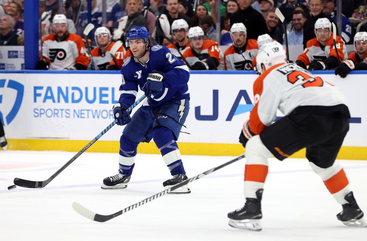 Mar 17, 2025; Tampa, Florida, USA;  Tampa Bay Lightning center Brayden Point (21) passes the puck as Philadelphia Flyers right wing Matvei Michkov (39) defends during the first period at Amalie Arena. Mandatory Credit: Kim Klement Neitzel-Imagn Images