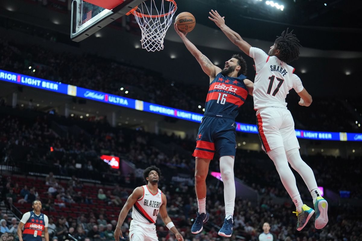 Mar 17, 2025; Portland, Oregon, USA; Washington Wizards power forward Anthony Gill (16) goes up for a shot against Portland Trail Blazers shooting guard Shaedon Sharpe (17)  during the first half at Moda Center. Mandatory Credit: Soobum Im-Imagn Images