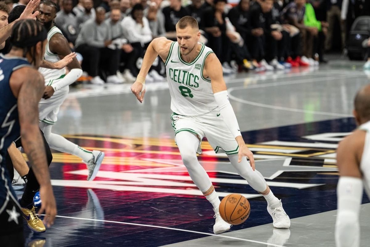 Nov 24, 2023; Orlando, Florida, USA; Boston Celtics forward Kristaps Porzingis (8) dribbles the ball against the Orlando Magic in the first quarter at Amway Center.