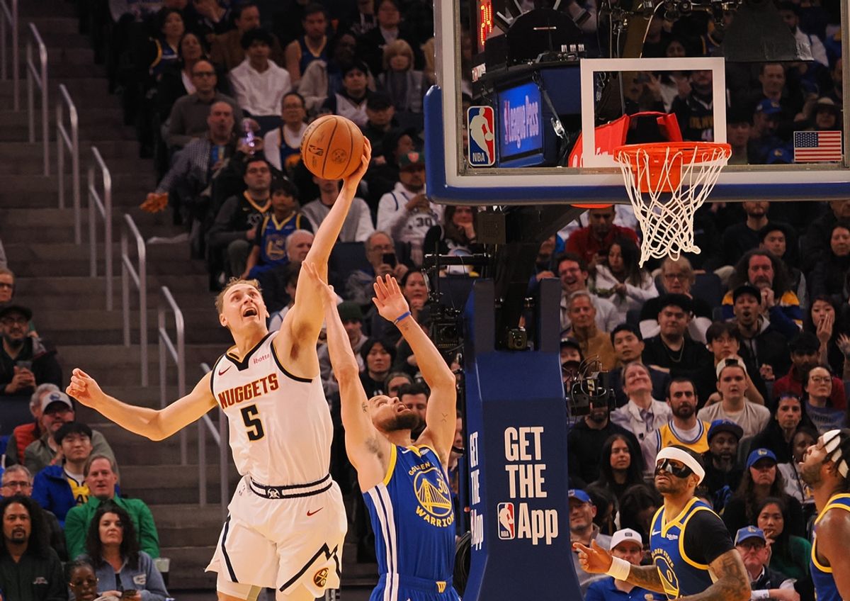 Mar 17, 2025; San Francisco, California, USA; Denver Nuggets forward Hunter Tyson (5) controls a rebound above Golden State Warriors guard Stephen Curry (30) during the second quarter at Chase Center. Mandatory Credit: Kelley L Cox-Imagn Images