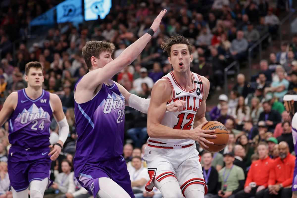 Mar 17, 2025; Salt Lake City, Utah, USA;  Chicago Bulls forward Zach Collins (12) tries to get past Utah Jazz forward Kyle Filipowski (22) during the second half at Delta Center. Mandatory Credit: Chris Nicoll-Imagn Images