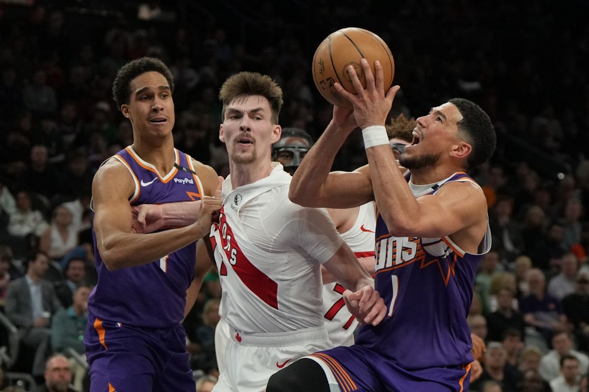 Mar 17, 2025; Phoenix, Arizona, USA; Phoenix Suns guard Devin Booker (1) shoots over Toronto Raptors center Colin Castleton (11) in the second half at Footprint Center. Mandatory Credit: Rick Scuteri-Imagn Images