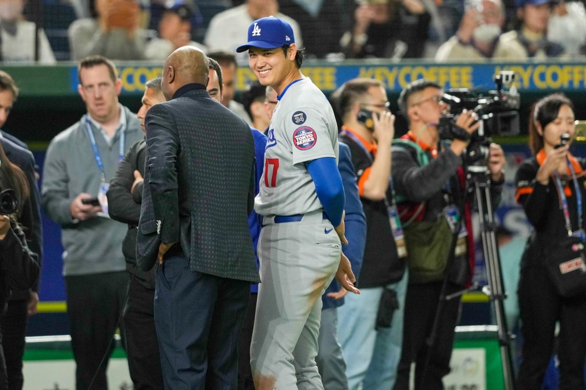 Mar 18, 2025; Bunkyo, Tokyo, JPN; Los Angeles Dodgers designated hitter Shohei Ohtani (17) (center) smiles after defeating the Chicago Cubs during the Tokyo Series at Tokyo Dome. Mandatory Credit: Darren Yamashita-Imagn Images