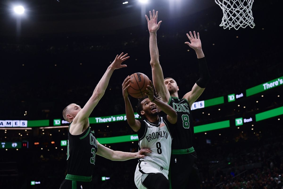 Mar 18, 2025; Boston, Massachusetts, USA; Brooklyn Nets forward Ziaire Williams (8) drives to the basket while Boston Celtics center Kristaps Porzingis (8) defends during the first half at TD Garden. Mandatory Credit: Bob DeChiara-Imagn Images
